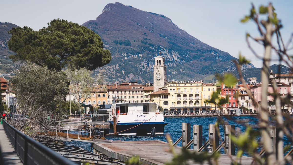 Uferpromenade von Riva del Garda mit Torre Apponale, Pinie und Fährschiff